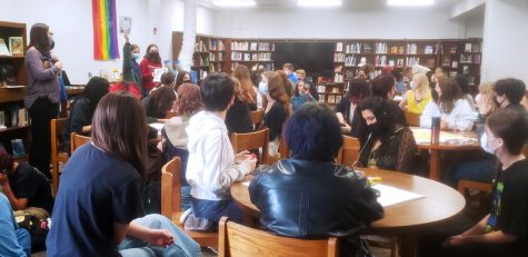 Juniors Sofia Dorsett and Clarissa Castro, who helped organize the student walkout on Monday, Nov. 14, address the large crowd of students who filled the library for the first meeting of McCallum Against Sexual Assault on Nov. 15.
