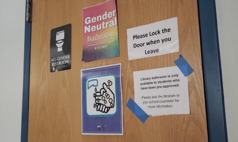 The door of the gender-neutral bathroom displays the same flyer that library interns posted all over the school. [We hope to] just make Mac a more open and safe community, so people feel comfortable, library intern Lucy Praxmarer-Holloway said.