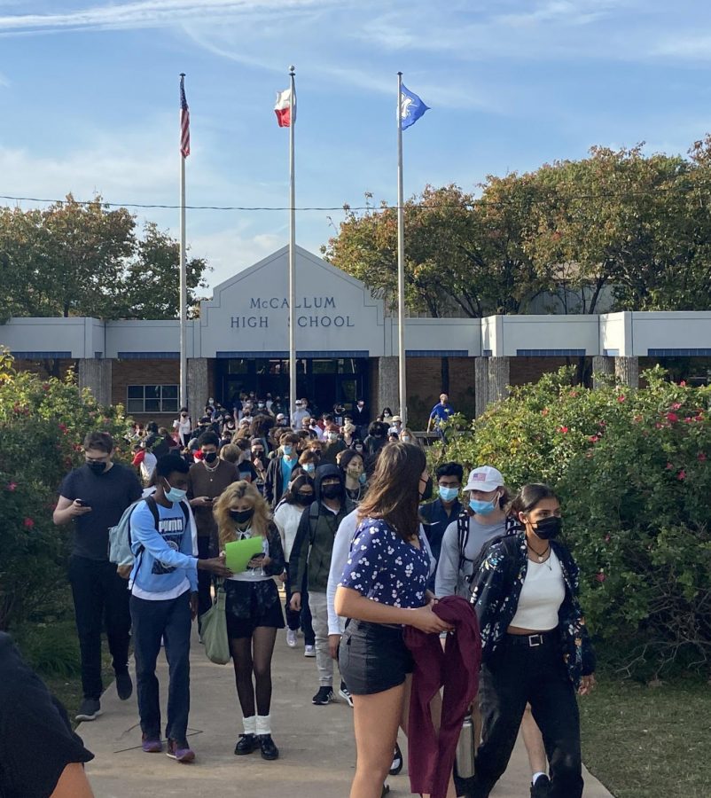 Students pour out of the front entrance in response to a fire alarm that went off at 3:10 p.m. during fourth period today. The alarm was triggered by a trashcan fire in the girls restroom on the University Boulevard hallway.