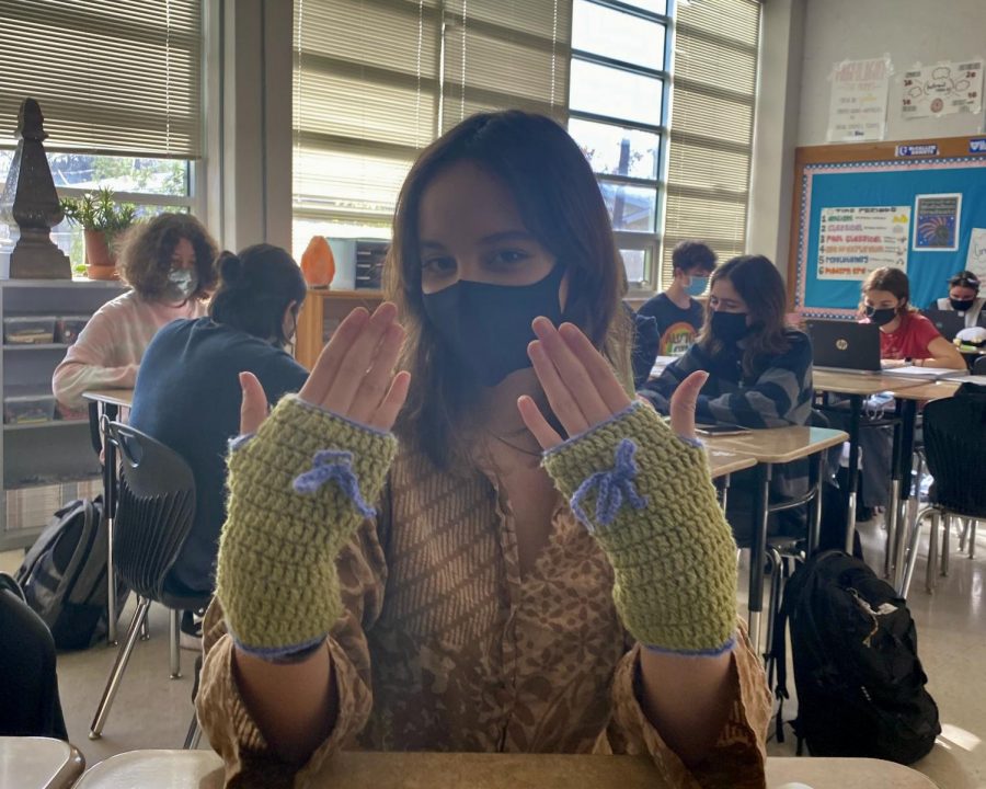 Sophomore Avery Atkinson models gloves that were crocheted by sophomore Anabel Tellez and purchased at a vintage clothing popup shop held by Tellez. In addition to selling clothes online with Depop, Tellez occasionally runs in-person resale events such as popup shops. “When I arrived at Anabel’s popup shop, I felt very welcome, Atkinson said. Everyone was friends and it was very casual. Her hand-made crochet items along with all the used clothes looked so beautiful together. Photo courtesy of Anabel Tellez.