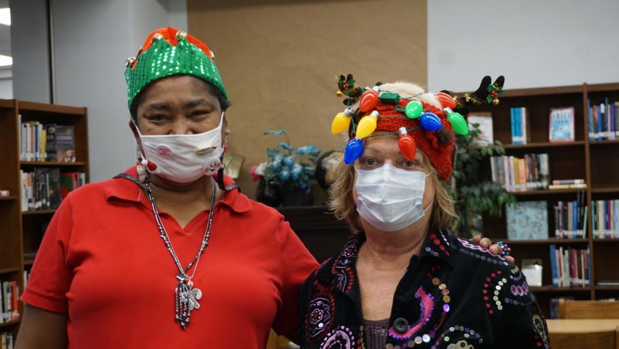 On the same day as the luncheon to celebrate her retirement, Beverly Evans (right) took the Maculty holiday spirit week prize for Best Holiday Headgear. Her colleague Sherryl Bailey (left) was a close second. 