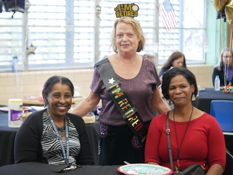 Beverly Evans stands with longtime departmental colleagues Helaine Brockington and Paula Hockaday at her retirement luncheon in Margaret Smiths classroom on Dec. 15.