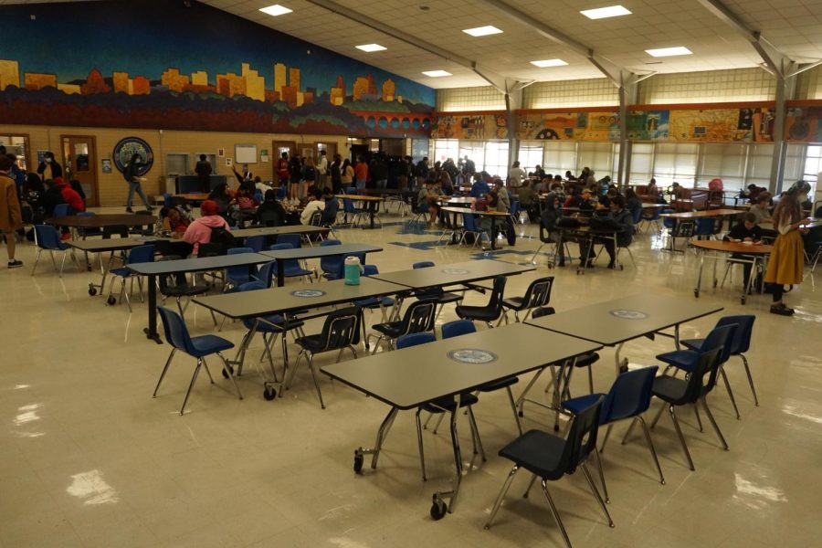 Cafeteria+tables+sit+empty+at+lunch+after+Austin+Public+Health+declared+that+Austin-Travis+County+had+returned+to+a+Stage+5+risk+factor.