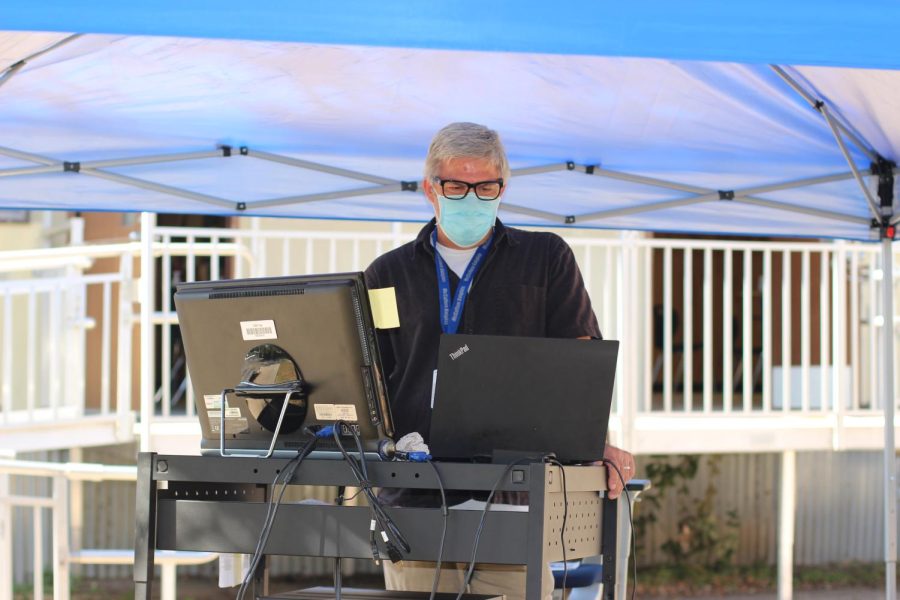 From the shade of his outdoor classroom, Eric Wydeven teaches English class over Zoom during the pandemic school year.