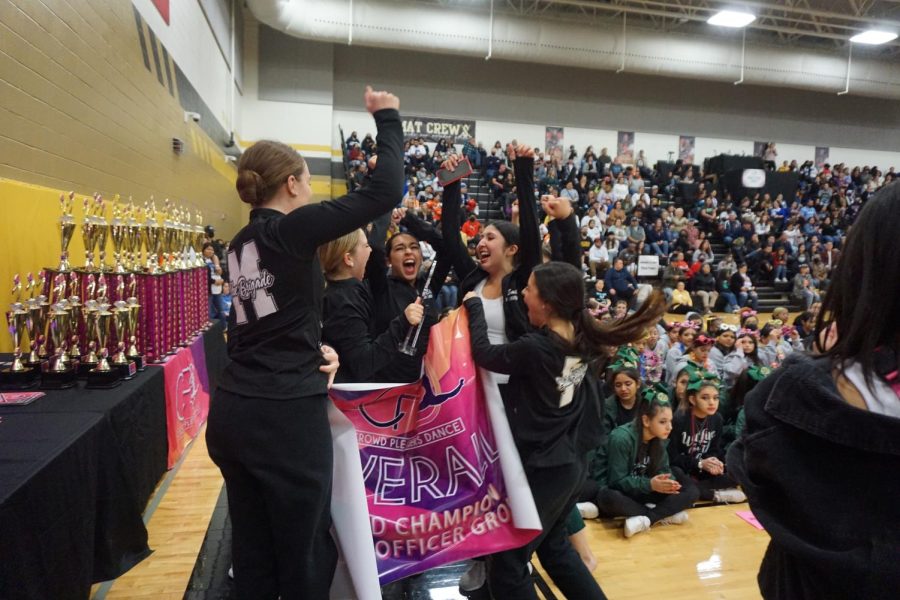 THEY ARE THE OVERALL GRAND CHAMPIONS: The Blue Brigade officers celebrate after winning the Overall Grand Champion Award as the top officer group at the Crowd Pleasers Dance Hill Country MS/HS Showcase on Feb. 19. For junior lieutenant Sophia Kramer, the teams success was more than just a good competition day; it was a redemption story. After a disappointing awards showing at Westwood High the week before, the haul of awards at Seguin was a rejuvenating relief. “There was a huge difference between both contests, and I feel like the whole team being there improved the energy of the dances overall,” Kramer said. “We were really cracking down on time and the day of the contest everyone stepped it up and played their part.” The Blue Brigade won a team Grand Champion Award in the large school category after all of their team dances placed first and earned platinum ratings. The three Blue Brigade duets swept first, second and third places with Kramer and senior caption Charli Cevallos bringing home first place for their duet Because of you. While Kramer is excited about her personal success, she found more joy in the teams result. “We were all so excited! she said. It felt so good having all of our hard work pay off, especially having to choreograph team dances and not necessarily having much time on our own.” Caption by Grace Nugent.