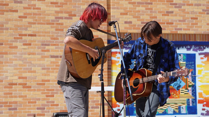 BALLADS AND BLUES: Sophomores King Perez-Cude and Joaquín Frazier, from the student band Red River Trucking Company, play a set of country-rock tunes, including traditional bluegrass tunes, Chris Stapleton’s “Midnight Train to Memphis” and an original song called “Ballad of an Outlaw Fugitive” at the Mr. Myers send-off concert. “We’re a rock band usually, but we have a lot of old school country and blues elements, so we decided to go acoustic,” Frazier said. He describes their style as complicated. “We’re kind of all over the place, but I would say blues or southern rock with some serious country and psychedelic influences,” Frazier said. Although he never met Mr. Myers, Frazier wanted to perform in honor of him. “[I] never got to know Mr. Myers, but I’ve heard great things he had done for our friends, and we wanted to play in honor of him,” he said. “We put together a short set together the night before and decided to go for it.” Reporting by Lucy Marco.