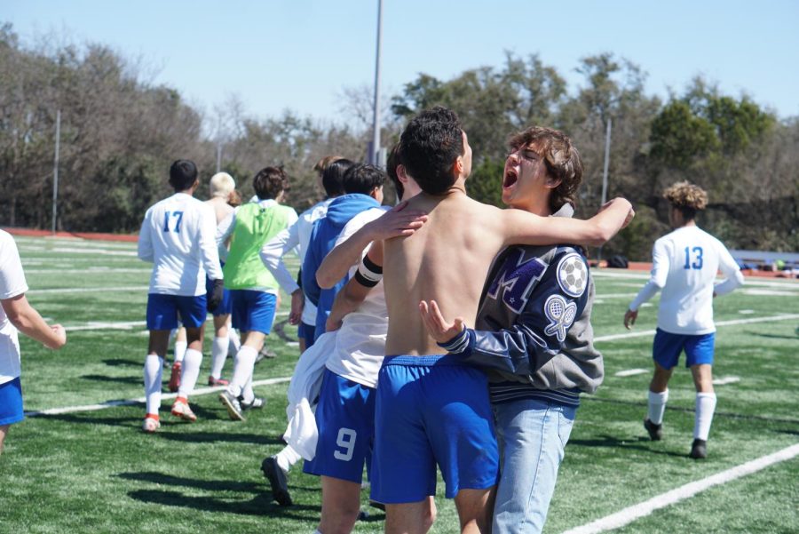Michael Alverson celebrates with teammates Silvio Guzman and Dash Levy after they clinched first place in the district with their 2-1 victory over the Anderson Trojans on March 12. 