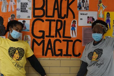 Senior Ashley Nicely and Fine Arts Academy clerk Tonya Moore pose in the Black Girl Magic contest T-shirts in front of the Black Girl Magic poster in the main hallway. The poster featured artwork created by students about what the Black Girl Magic movement means to them. On Feb. 17, junior Regan Sims and sophomore Jendayi Innocent were named the winner and the runner up in the contest. Black girl magic is so important because we have to teach our kids that theyre beautiful no matter what skin tone they are, Moore said.