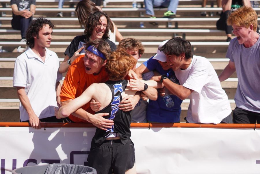 MAKE THE FAMILY PROUD: Chris Riley was met with a swarm of overjoyed friends in the stands after his record 1600m run.

One of those friends, Alex Tita, experienced firsthand how much Riley had trained for moments like these, and couldn’t be more proud of him.

“I was so proud of him. Watching him cross the finish line with not only a personal record, but a school, and meet record was very special. His dedication to running is unmatched, and I hope to see him cross the finish line with even more record breaking times in the future.”

After missing the entirety of his cross country season with a stress fracture, the dedication that Tita mentioned has become Riley’s greatest weapon. Through 60 mile weeks and hours upon hours of training, he’s been able to propel himself, not just back to where he was pre-injury, but much, much, faster.

With the way he’s been running this season, it will be no surprise to anyone when there are many more moments like these. Riley will only run faster, and the stands will once again fill with crowds of people ready to watch the show. Caption by Thomas Melina Raab.