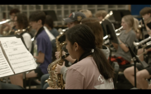 Junior Stephanie Gallegos plays the alto saxophone as part of the bands learning, performing and recording the Ukrainian national anthem during first period on Wednesday.