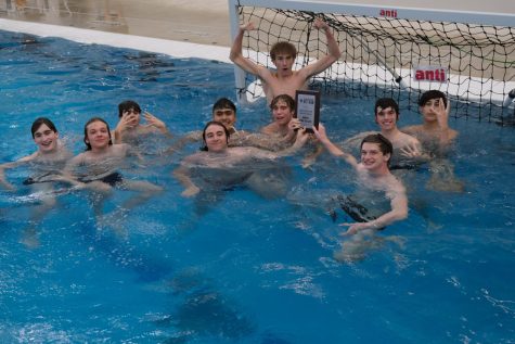 At the conclusion of the tournament, the team celebrates in the pool with their second place plaque. The exception is goalie Jamie Guckenburger who leaped out of the pool in celebration, perhaps because his team is headed to state and perhaps because he made 10 saves in the championship game.