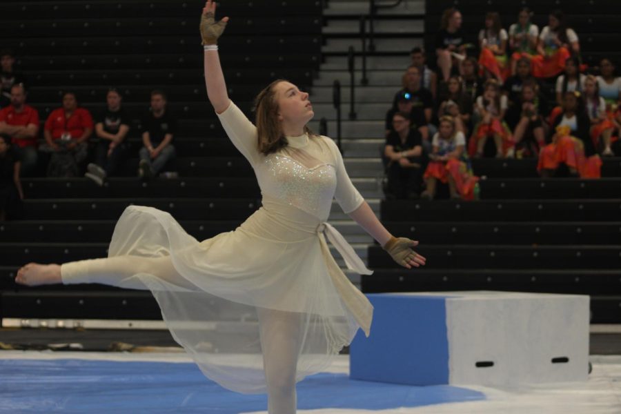 Freshman Audrey Eberly performs at the guard's first show at the TCGC Championships. The guard members had to adapt by counting paces aloud when the audio suddenly cut out mid-performance.