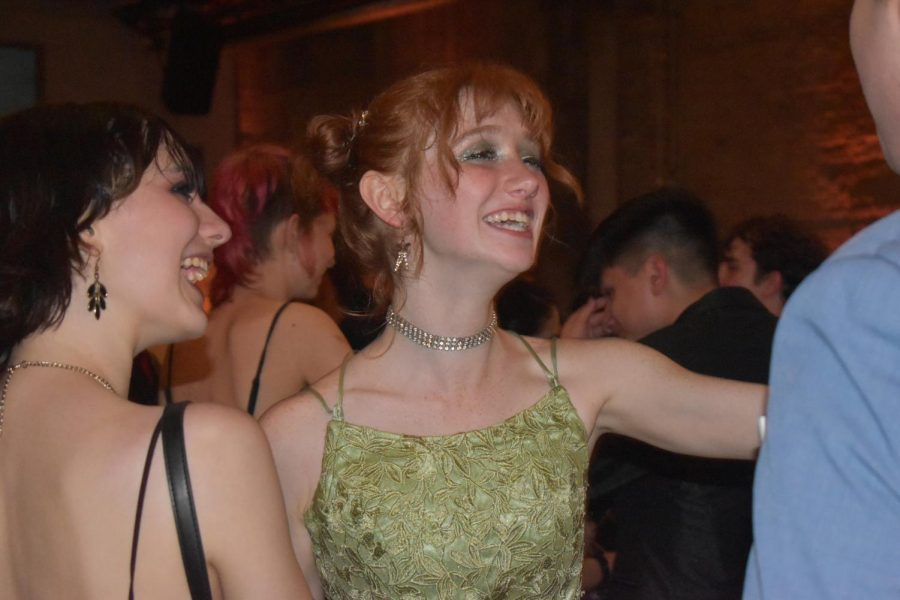 GOING OUT IN STYLE: Senior Lucy Nichols socializes on the dance floor. Fittingly for the theme of old Hollywood, Nichols dress was vintage. “Prom was really incredible for me,” Nichols said. “At first it was really loud and intimidating, but pretty quickly I was able to loosen up and just focus on having a good time.” Nichols also enjoyed how prom brought the class of 2022 together. “Everyone looked really beautiful and it was so nice to just see everyone have a good time all together for once.” Caption by Grace Vitale. 