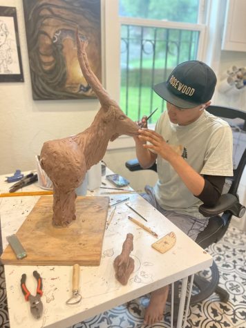 Junior Callan Spence working on a sculpture of the University of Texas Longhorn mascot. Spence sees the UT fine arts program as one of many possibilities for his future as an artist. Photo courtesy of Chas Spence. 