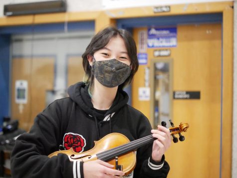 Krische poses with her violin before all-state Orchestra. She had qualified the year before, but the performance had been canceled due to COVID. Photo by Lanie Sepehri.