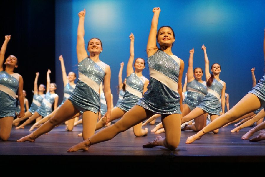 FIVE-STAR CAPTAIN: In One Night Only, the opening number of the spring show on Saturday night, Blue Brigade captain Charli Cevallos is front and center setting the mood and tempo for the number and entire show. Cevallos said the opening number of the spring show is always upbeat and fun and this year’s edition was no exception. Cevallos said she remembers the moment as one of pure adrenaline. “Since opener is the first dance, the excitement is running high and it’s such a great feeling to be performing our hard work for an audience.” As the photo suggests, the team was able to perform the number in sync even though it was a new dance choreographed exclusively for the spring show by first lieutenant Annabel Winter (left) and senior lieutenant Emily Garza. “Opener was our first spring show dance we learned,” Cevallos said, “and it came together super well. … [It was] definitely a team favorite.” Cevallos said her favorite part of the number was the very beginning when Winter (left) woke her up stage left from a deep sleep to start the show. “It’s so fun,” she said, “and the audience loved it.” For the first time in three years, that audience was in the MAC and at full capacity without pandemic restrictions.