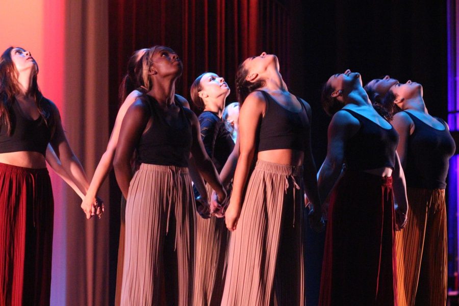 ONE LAST HURRAH: Members of the senior dance company hold hands at the end of their piece called Sound and Color, the closing dance of the student directed-dance show. “It’s a very sentimental moment because it’s like the end where we all are holding hands and were all connected,” senior dance company member Wynter Winston said. “The senior dance was wholesome and had us reflecting on all the times and memories we shared together as a senior company.” Caption by Grace Vitale. Photo by Meredith Grotevant.