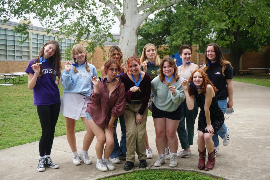 The staff members who earned Best of the Best in Texas in Online News Packages show off the TAJE gold medals they earned for their online gallery of Mac VASE winners. Front row: Lydia Reedy, Josie Bradsby, Alice Scott, Lucy Marco. Back row: Samantha Powers, Evelyn Griffin, Evie Barnard, Anna McClellan, Kate Boyle and Sofia Ramon.