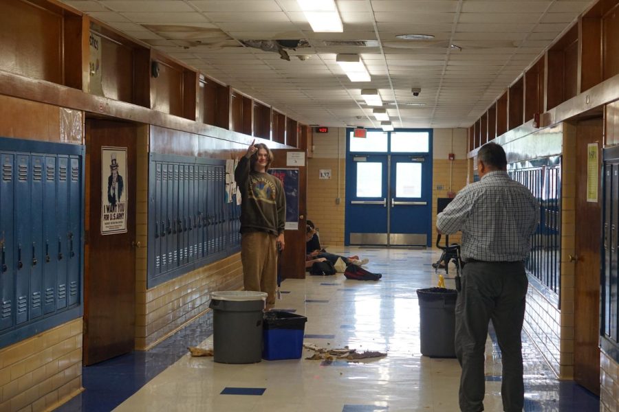 While Fine Arts Academy director Gabe Reyes inspects the damage last April, then senior William Benson points to an all-to-common Mac malady: a water leak, this one outside of history teacher Clifford Stanchos's classroom.