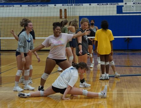 Returning varsity players Allie Roshalt, Saraih Taylor, Vaughn Vandegrift and Rachel Nabhan enjoy a light moment during tryouts after Nabhan attempted a dig and ended up in a split during a scrimmage point.