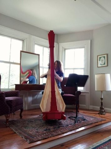 Gernert practices on a rare red Salzedo harp at the Maine Coast Harp Institute.