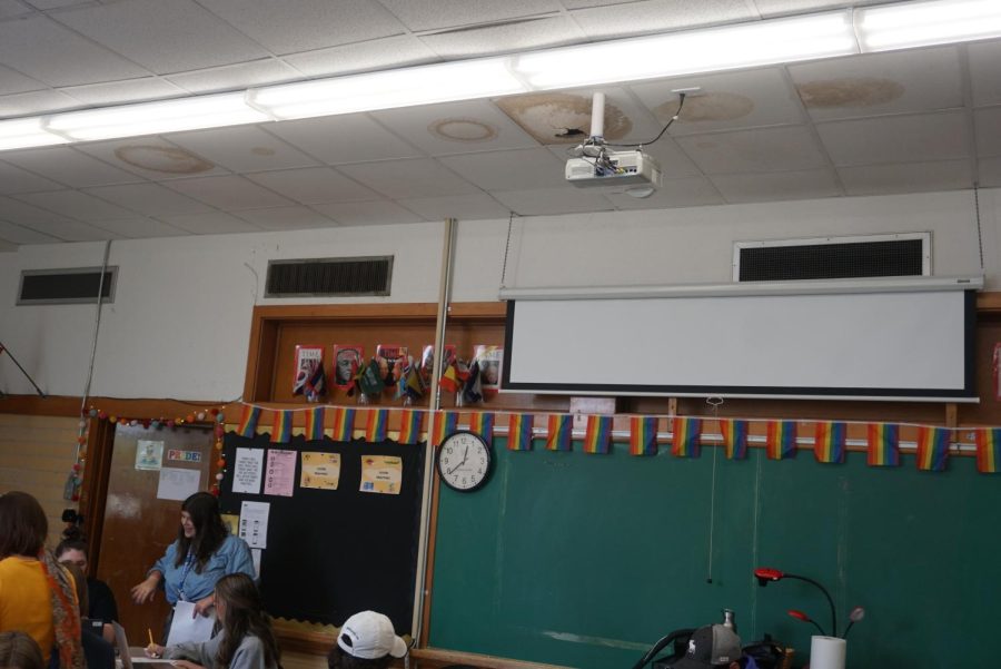 Ceiling panels bloat and sink, forming brown rings due to water damage in room 113 as Ashley Friedman teaches her AP World History class during sixth period on Tuesday.