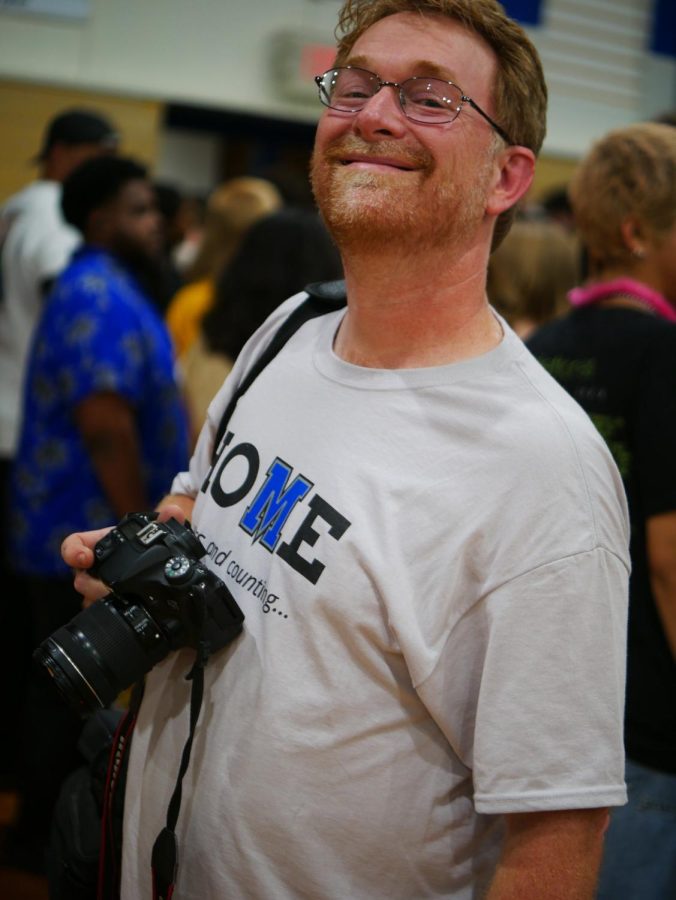 Frank Webster smiles for the camera while photographing last Thursdays pep rally.