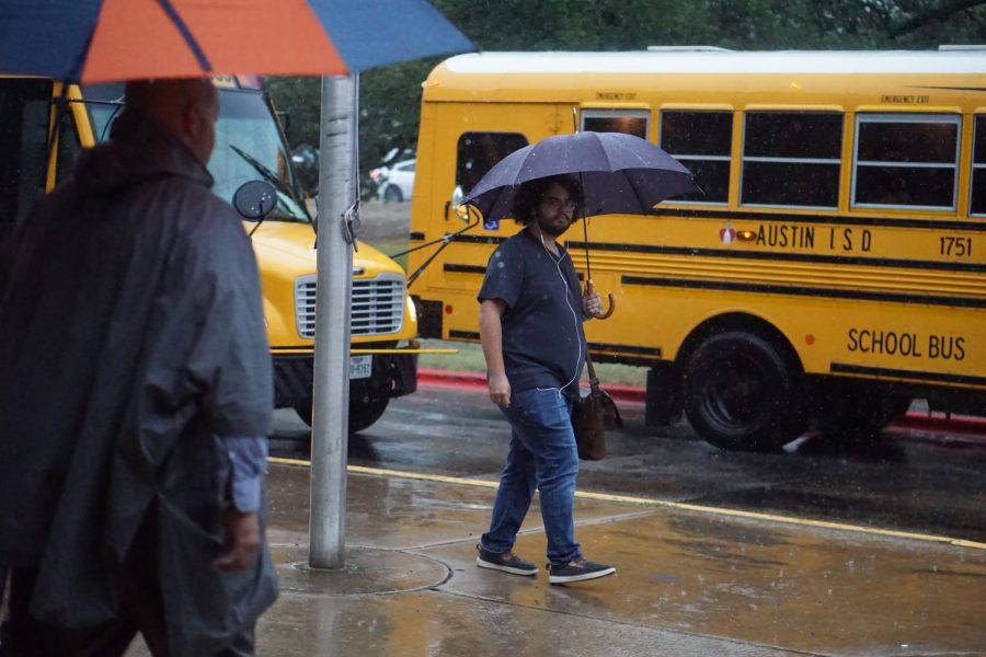 UNDER THE UMBRELLA: Junior Wilson Corbitt heads toward his dad’s car near the portables during Monday afternoon’s rainstorm. Corbitt faired better than some students, having the forethought to bring an umbrella to school. “In that moment I thought ‘I bet you all thought I was crazy for bringing an umbrella on a sunny day,’” Corbitt said. His intuition proved right, but Corbitt connects this occurrence to a larger issue facing Austin and the planet. “Every year the weather in Texas gets more and more unpredictable and severe due to climate change,” Corbitt said. “And that’s coming off the back of one of the hottest summers on record where today was the first day since May under 90 degrees, which is making it progressively difficult to tell what might happen.” Reporting by Alice Scott.