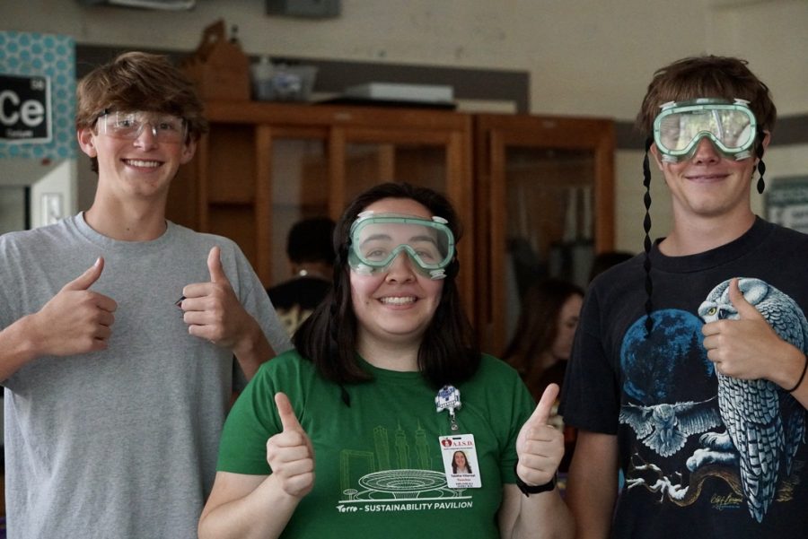 First-year chemistry teacher Tabitha Villarreal poses with students during a lab.