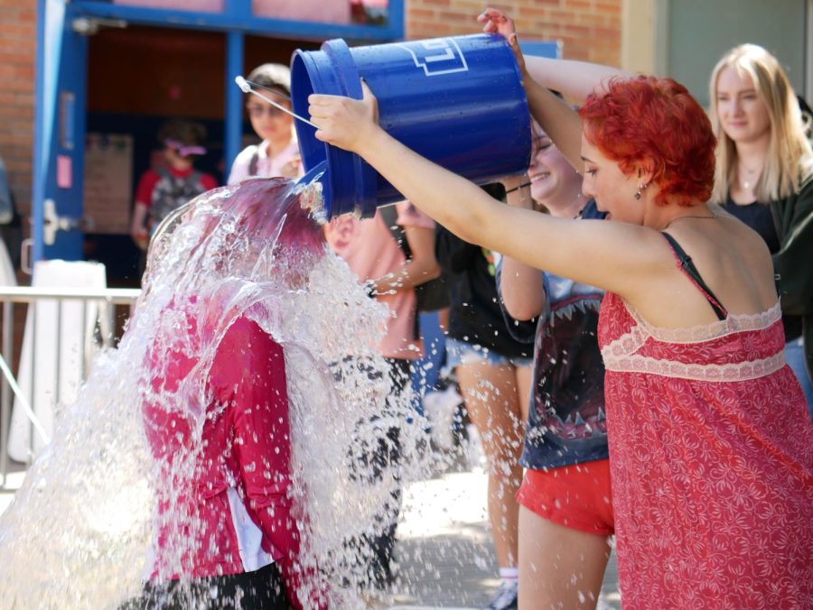 BUCKETS OF FUN: During lunch on Tuesday and Thursday, students in the PALS program volunteered to be drenched in water to raise money for the local charity Breast Cancer Resource Center (BCRC). Students had the opportunity to purchase a bucket of water for $10 and dump it on a PAL of their choosing. “The water buckets were definitely one of the reasons we were able to raise so much and beat our record,” senior Josie Bradsby said. “Pink week came a little early this year and I was pleasantly surprised that we were able to do so many activities successfully. It’s a great way to give back to my community and spread awareness and a sense of togetherness around McCallum.”
Caption by Jojo Bernard