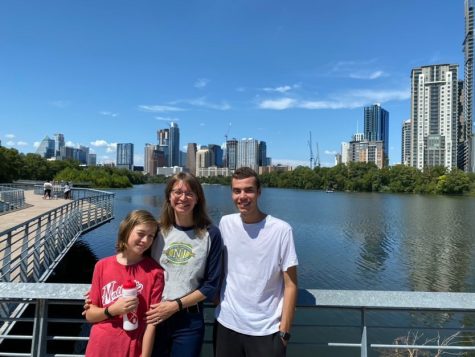 Gergő Major poses in front of the Austin skyline with host mom Anita Salmon and host brother Seth Salmon. 