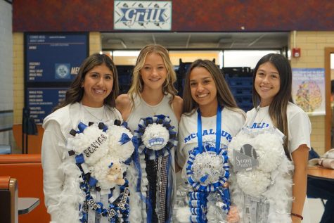 MUMS AND MEMORIES: Seniors Gia Ruedas, Stephanie Renee, Kayden Williams and Ary Sanchez wear their mums proudly on White Out Day. Ruedas said that getting to wear a mum as a senior was a dream come true.

“I have had a mum every year since I was 3 years old,” Ruedas said. “My mom always made them for me but this year I decided to do it on my own. I’ve always looked forward to my senior year to finally make my final mum and make it special. It made my homecoming special because it was the last mum I was going to ever make for myself.”

Ruedas said her favorite part of homecoming is spirit days, which was made even more fun by the introduction of Soccer Mom vs. BBQ Dad Day. As a cheerleader, Ruedas was excited to show off what the cheer team had been working on during the pep rally on White Out Day. But experiencing her last McCallum homecoming was bittersweet. 

“When I graduate I’m going to miss everything about McCallum homecoming,” Ruedas said. “Making my mum, dressing up for spirit days, seeing the decorated hallways, performing in the pep rallies and especially being on the sideline cheering for our school football team.”