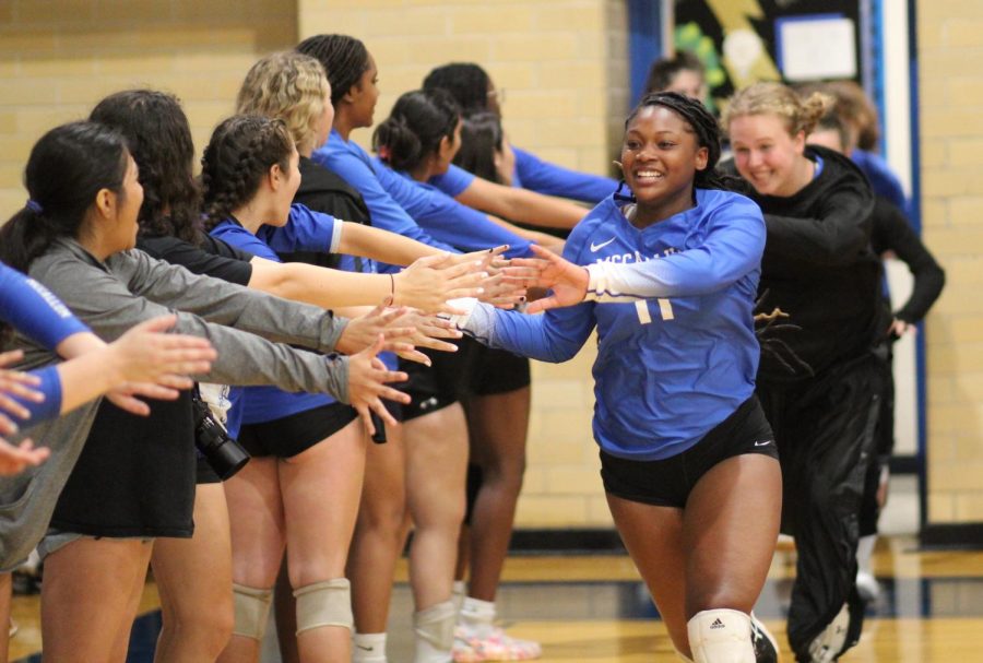 COOKING UP SOMETHING SPECIAL: She may not have earned the title of Statesman Girls Athlete of the Week, but the way the school rallied to champion her cause had to feel like a big win for senior setter Teasia Cooks (shown here leading her team out for an eventual home sweep of Eastside on Sept. 13). After averaging nearly a double-double with assists and digs in leading the Knights to a five-game win streak and an early perch atop the district standings, the Statesman named the affable senior setter as one of four girls volleyball players to earn Player of the Week honors. After a PR blitz that included social media promotion, QR Code leaflets throughout the school and even a rally cry on the morning announcements, Cooks received 9,440 votes, 41 percent of the total.

“I didn’t know that I was nominated until my moms friend told us,” Cooks said. “Once we found out we were shocked and were like, ‘We are fixing to have a lot of people vote.’ On the last day of the vote we posted flyers around the school saying to vote for Teasia, and the teachers let me say my speech at the pep rally. It was a really good experience.”

Photo by Naomi Di-Capua.