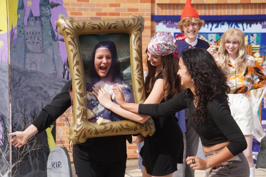 NSPA Fall 2022 Best of Show winner

JoJo Barnard, feature photo, sixth place

"A SWEET SURPRISE"

Senior art society officers Amaya Collier and Claire De Silva-Yost smear cake on their advisor, Sara Massey. The students thought it’d be funny to cover Massey, who was dressed as the Mona Lisa, with cake, because the famous work was recently vandalized with the dessert.

“I liked seeing all our efforts being enjoyed by everyone in school,” De Silva-Yost said. “I saw so many smiles.”

De Silva-Yost found the stunt to be extra exciting considering that the acts of vandalism are still currently happening, with the most recent occurrence being last Thursday, targeting the painting “Girl With a Pearl Earring” by Johannes Vermeer. Although it isn’t certain that the defacing of the Mona Lisa corresponds with the more recent outbreaks, De Silva-Yost wouldn’t be surprised if the two were linked.

“I support the protests’ message to stop using oil,” De Silva-Yost said, “but I think they executed it in a way that lacks a clear message to the public.”