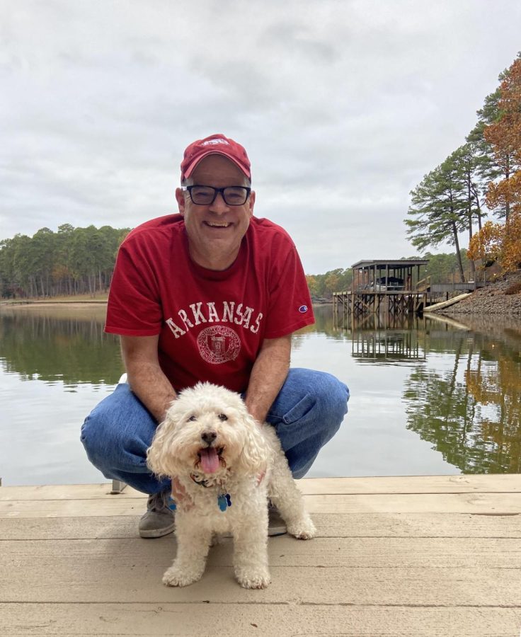 BEST FRIENDS FOREVER: Digital media teacher and Shield adviser Dave Winter and his bichon-frise poodle mutt Marty pose on a dock in front of Lake Hamilton in Hot Springs, Ark. The Winter family, including Dave’s wife Jennifer and children Henry (class of 2020) and Annabel (class of 2022) reconnected with Jennifer’s twin sister’s family and her dad and stepmom during the break.

“Hot Springs was perfect because it was about halfway between central Texas and Atlanta, where my wife’s sister’s family lives,” Winter said. “It is a beautiful location and also in the same state where Annabel attends the University of Arkansas. Unfortunately, it rained the whole time we were there, and Marty had to show my sister-in-law’s dogs that he was the alpha dog.”

Despite these setbacks, the family enjoyed the time together playing board games, blackjack and watching World Cup soccer. They also had Thanksgiving dinner at The Arlington Hotel in Hot Springs.

“A Thanksgiving dinner with no cooking and no dishes,” Winter said. “That’s the way to do it.” Photo by Annabel Winter.