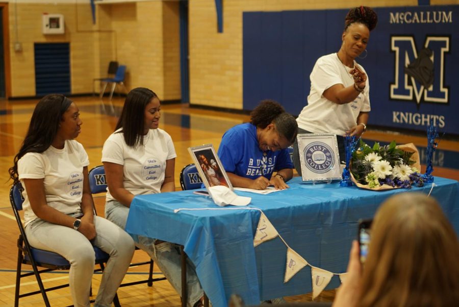 SHE’S COMMITTED: Surrounded by friends, family, and teammates in the Mac gym, senior Saraih Taylor officially signed Tuesday to play collegiate volleyball at Rust College,

Although developing into a collegiate-level athlete has been a long and demanding process, Taylor knew it was all worth it when signing day rolled around.

“It’s lots of crying and putting my body through a lot,” Taylor said. “Over the past year, I’ve had three concussions. I’m always having to push through that. And I’m always going from one practice to the next and not having time to hang out with friends or anything because I’m always busy. So it’s just really exciting to see all that hard work and time I put in actually pay off.”

Taylor’s development as a volleyball player was just one piece of the puzzle. While her athletic recruiting process did involve lots of communicating with college coaches and attending showcases, it also called for a more personal search for the perfect school and community---which Taylor found at Rust.

“It’s a Historically Black College, which I was always looking for because I’ve always been the only Black girl on most of my teams,” Taylor said. “They’ll know the struggles of being the only Black girl on the team, so we’ll all kind of know each others’ background, and we’ll all have something in common from the jump.”

Even as a new recruit, Taylor feels bonded with the program and her future teammates.

“I know that they’re basically gonna be my family,” Taylor said, “I met the girls, and they were like my big sisters automatically.”

Taylor’s real family have been cheering her on throughout the commitment process as well, even sporting Sariah-themed T-shirts on signing day.

“They were definitely super excited,” Taylor said. “They have supported me from when I started playing at the age of six until now. I think it’s really big for them to actually see me grow up in the volleyball world.”

Taylor’s teammate since seventh grade, senior Rachel Nabhan, has also watched her grow up in the volleyball world. According to Nabhan, Taylor’s collegiate commitment is a testament to her determination throughout the years.

“I know she’s a really hard worker, and it’s just really inspiring because I know each day she’s on the court, she’ll hustle,” Nabhan said. “And have you seen her serve?”

Photos by Maggie Mass. Caption by Caroline Owen.