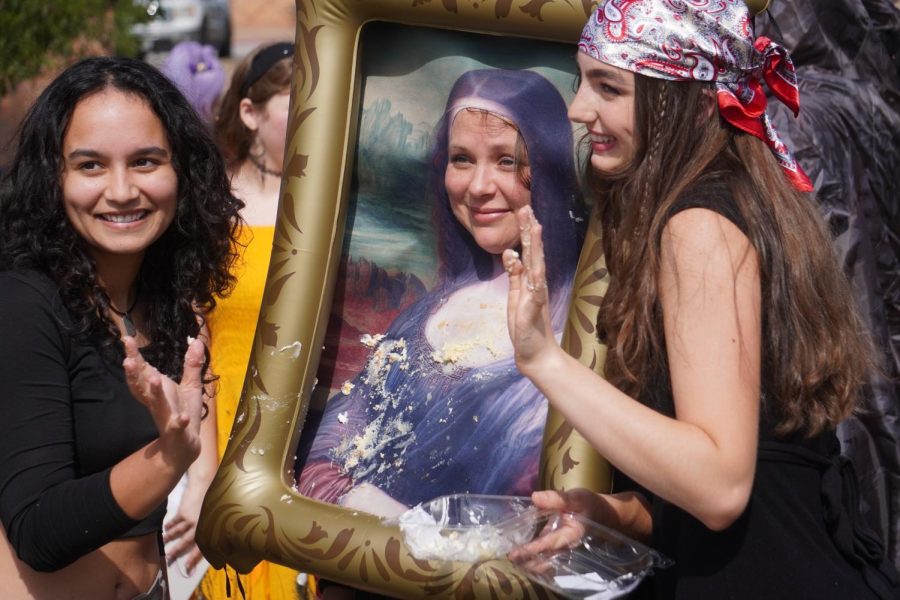 A SWEET SURPRISE: Senior art society officers Amaya Collier and Claire De Silva-Yost smear cake on their advisor, Sara Massey. The students thought it’d be funny to cover Massey, who was dressed as the Mona Lisa, with cake, because the famous work was recently vandalized with the dessert.

“I liked seeing all our efforts being enjoyed by everyone in school,” De Silva-Yost said. “I saw so many smiles.”

De Silva-Yost found the stunt to be extra exciting considering that the acts of vandalism are still currently happening, with the most recent occurrence being last Thursday, targeting the painting “Girl With a Pearl Earring” by Johannes Vermeer. Although it isn’t certain that the defacing of the Mona Lisa corresponds with the more recent outbreaks, De Silva-Yost wouldn’t be surprised if the two were linked. 

“I support the protests’ message to stop using oil,” De Silva-Yost said. “But I think they executed it in a way that lacks a clear message to the public.” Caption and photo by JoJo Barnard.