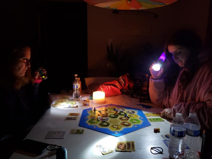 Junior Annabel Winter plays the board game Catan with her parents in their powerless house on Monday night. Like many families in Austin, the Winters lost power around 2 a.m. Monday morning and didn’t have their power restored until three days later on Wednesday afternoon around 5 p.m. “It was a surreal experience,” Winter said. “It felt kind of apocalyptic because we were holding flashlights and were all bundled up in blankets, kind of like a dystopian novel.” Photo by Dave Winter.