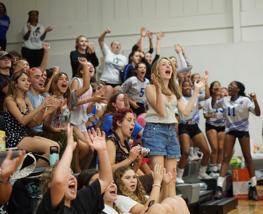 ROAD COURT ADVANTAGE: Mac fans erupt in celebration as the Knights win a point en route to their straight-set victory on the road at LASA on Sept. 9.  Senior Julia Wallace was among the boisterous Knight fans who traveled with the team to encourage them as they played.

“I was so excited that varsity was killing it and beating LASA,” Wallace said. “I thought it was a really good game. The team really had to play. There was good competition, and we still pulled through and won.”

The win was the varsitys fourth district win in four tries. It came quickly as Mac jumped out to an early first-set lead and never looked back. “

We put a lot of effort and training into this game,” senior co-captain Rachel Nabhan said. “It was nice to see it pay off.”

The first set was the closest the game got, with a score of 25-18. As the game progressed and the Knights gained more confidence, the sets got shorter and shorter. The second produced a score of 25-13, and the third, 25-9. Photo by Jolie Gabriel. Reporting by Lydia Reedy and Jolie Gabriel.