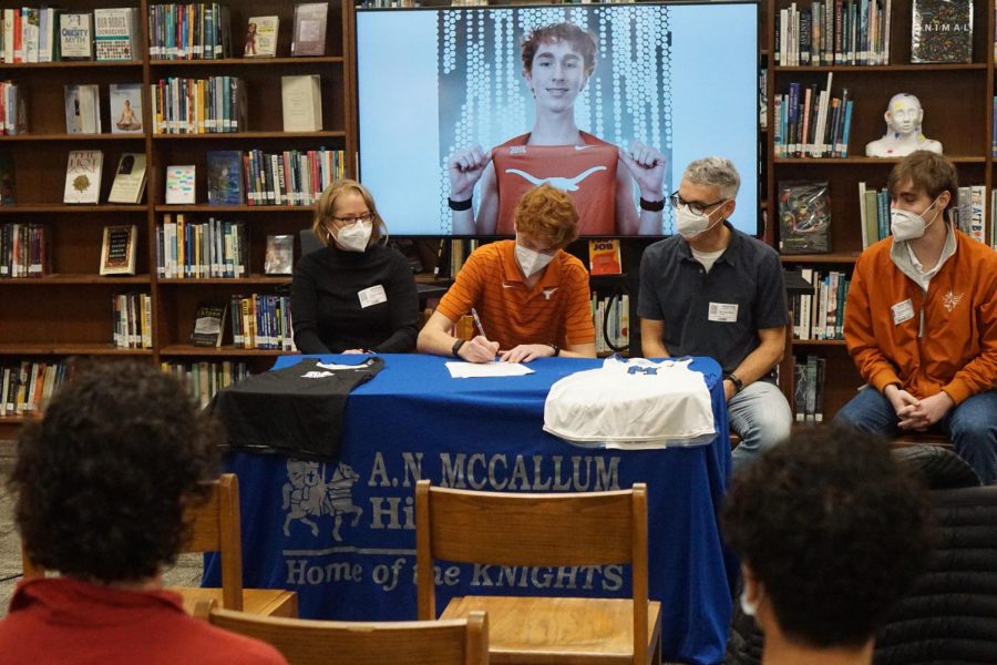 It’s officially official, Chris Riley is a Longhorn. On Monday, Riley signed his National Letter of Intent to attend the University of Texas surrounded by friends and family.

For the next four years, Riley hopes to make his school, his coaches, his peers and his family proud as he runs with the burnt orange on his chest.

As Coach Houston put it, “This is a special day for athletes all around the country.”

For Riley, this was his day.

Coach Houston, Coach Gammerdinger, and even Coach Ashton were there to support him as he took the next step in his athletic and academic career.

Once pen was put to paper, Riley was quick to thank McCallum for his time here, saying

“If I didn’t go to McCallum, I don’t think I would have been as interested in running as I am today.”

He then thanked his club coach Paul Carrozza, who he said has played a huge part in his training over the years. After some reluctance, to which he attributed to having thanked them every day, he finally thanked his parents sitting beside him.

Coach Ashton, Riley’s cross country coach for three years, closed out the day with some encouraging words from the past and for the future.

“The first day I saw you I knew you were going to do big things,” Ashton said.

After four years, it’s pretty safe to say Riley has.

Track season starts very soon, and he will only hope to do even bigger things before he departs for the 40 acres.