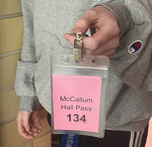 Junior Helen Martin carries a pink hall pass that designates which bathroom correlates to her classroom.