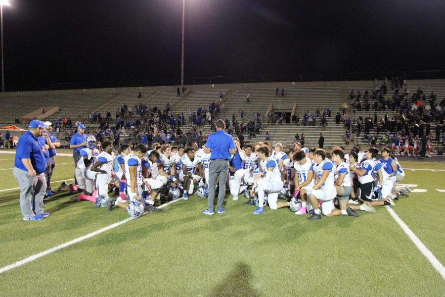 The Varsity football team gathers on the field during the Oct. 21 game against Navarro.