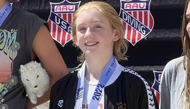 Freshman Iris Burns-Trahanovsky poses with her medal from the 2022 AAU national diving meet, where she placed fifth. 