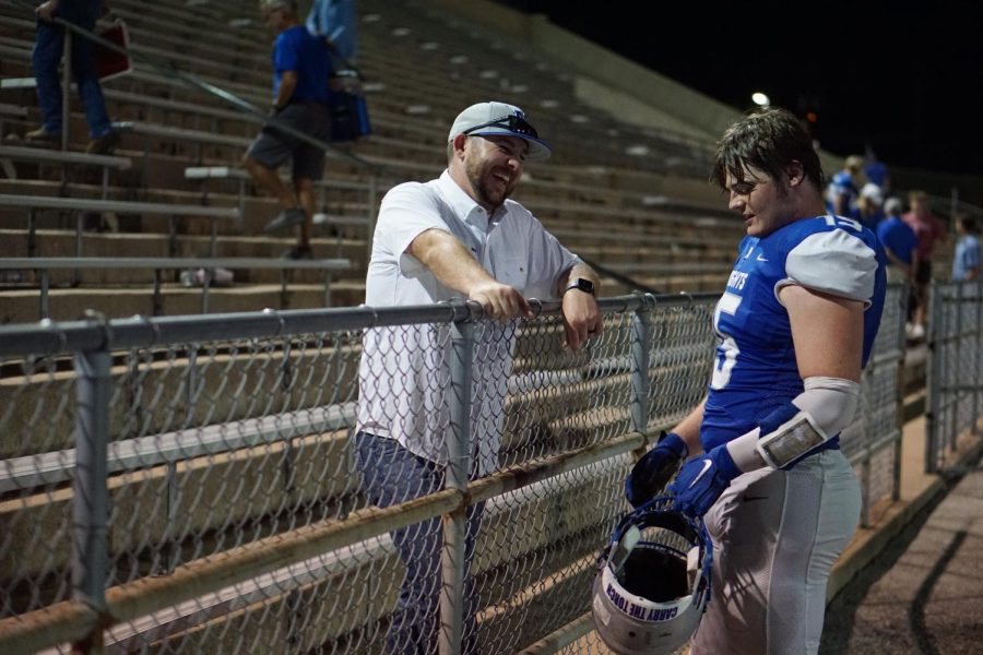 Brandon Grant and senior Miles McCollum reunite after a McCallum football game. 