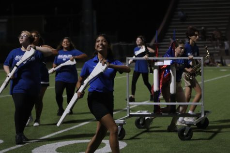 Senior Ximena de la Garza performs with the color guard in their athletic trainer uniform at the McCallum vs. Crockett halftime show. Moving from the sidelines to the field during halftime usually isn't too much of a challenge thanks to de la Garza's effective time and stress management skills. “Stressing is the last thing you want to do with multiple activities,” de la Garza said. “It throws everything out of balance, and it’s so important to handle."