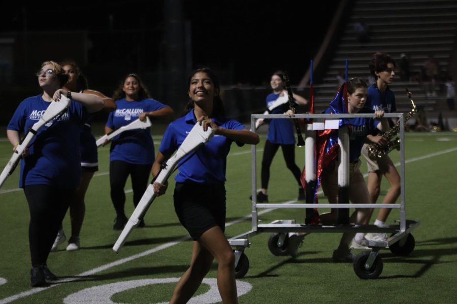 Senior Ximena de la Garza performs with the color guard in their athletic trainer uniform at the McCallum vs. Crockett halftime show. Moving from the sidelines to the field during halftime usually isnt too much of a challenge thanks to de la Garzas effective time and stress management skills. “Stressing is the last thing you want to do with multiple activities,” de la Garza said. “It throws everything out of balance, and it’s so important to handle.