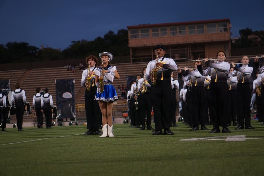 Lili Escamilla performing at the McCallum homecoming halftime show, playing the saxophone in her Blue Brigade uniform. Escamilla's passion for the musical and dance aspects of the halftime performance motivates her to work around the two activities conflicting practice schedules. “It does get stressful, there are so many things I have to remember,” Escamilla said, “but I have learned to manage it, and now I don't have to stress about it." 