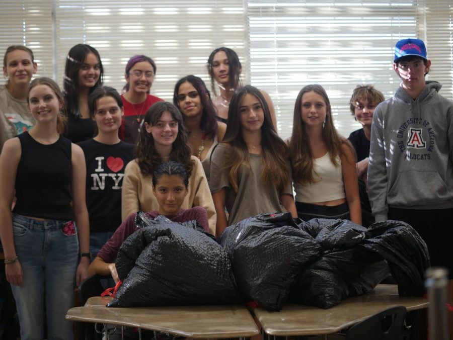The Environmental Knights club pose for a photo after picking up trash around campus. 