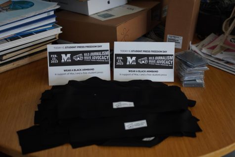 A display of black armbands, reminiscent of the armbands worn by Mary Beth Tinker and others in 1959, on a table in Room 134 for students to take during Student Press Freedom Week. 