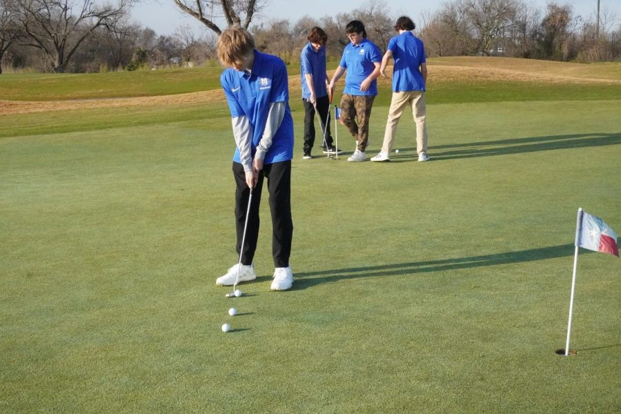 The boys golf team practices putting at Morris Williams Golf Course on Feb. 16.